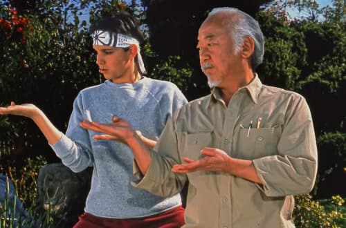 Mr Miyagi of The Karate Kid, mid-motion, his hands caught in a gesture the young would now recognise at once as 6 7