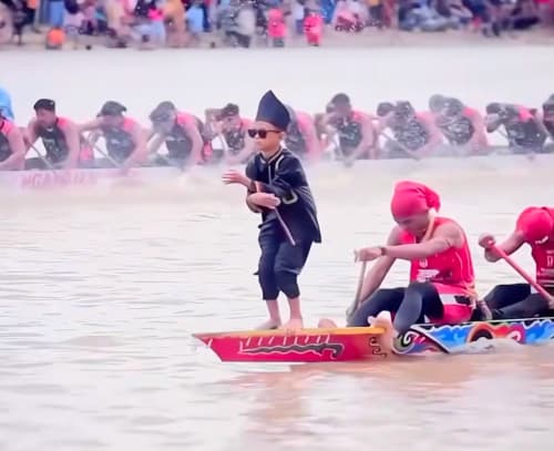 Rayyan Arkan Dikha, eleven, dancing on the prow of a racing boat at the Pacu Jalur festival in Riau, Indonesia